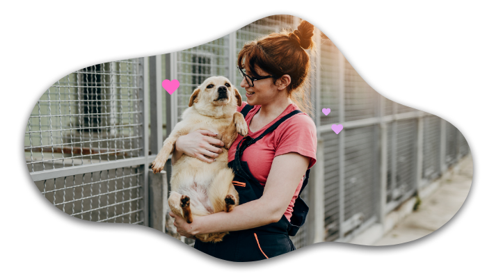 Woman in overalls cuddles a small dog, both appearing happy, with pink hearts around them.